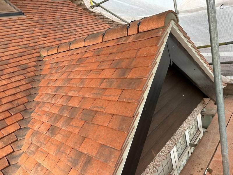 Clay tile roof with a gable dormer finished in white UPVC bargeboards