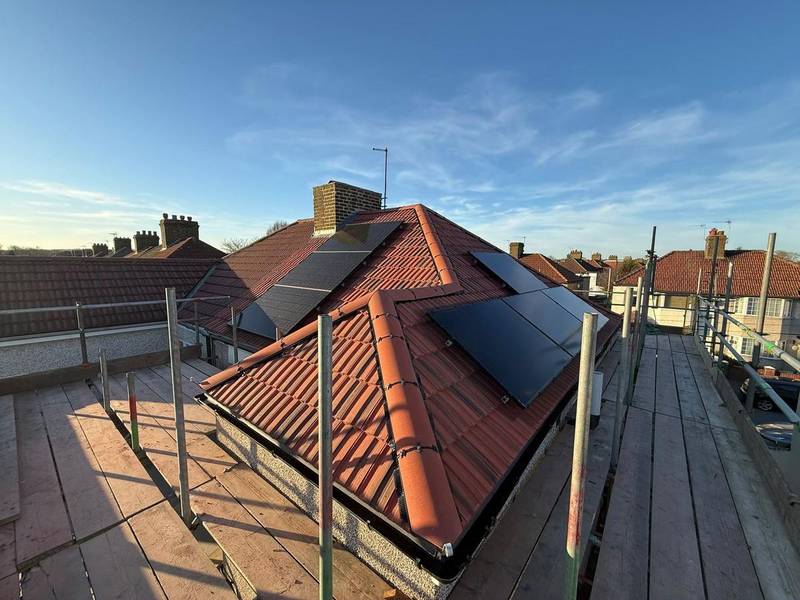 Clay tile hip roof with a rooflight, seen from the scaffold