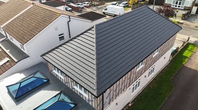 Aerial view of a grey tiled roof with roof lanterns on a flat-roofed extension